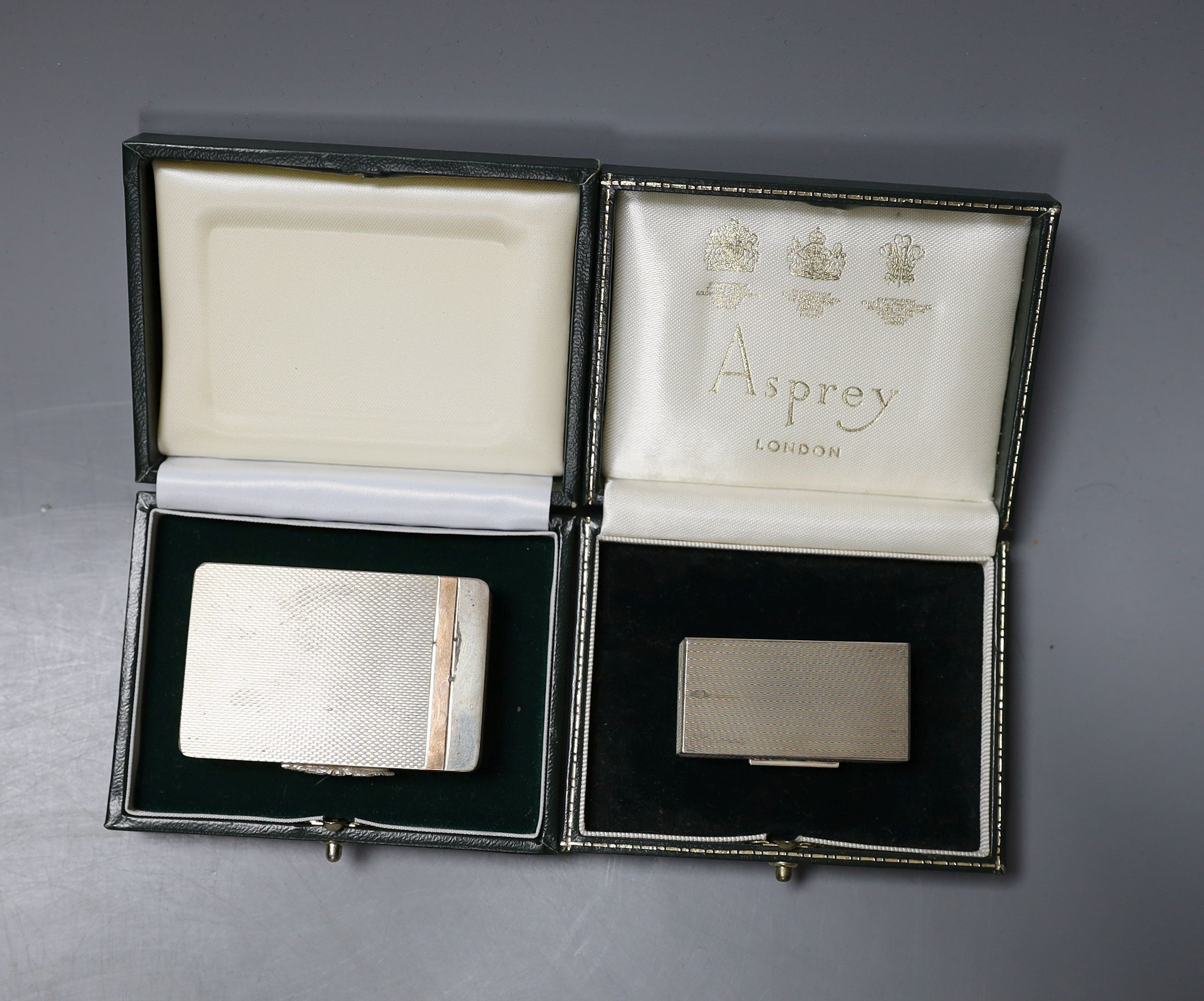 A cased modern engine turned silver pill box by Asprey & Co, Birmingham, 1965, 49mm and a later cased silver pill box by William Asprey.